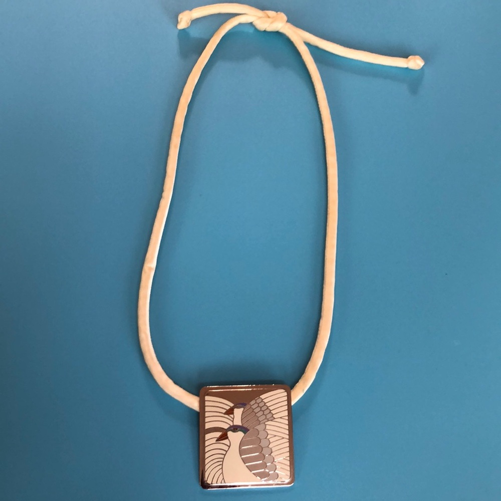 Vintage Laurel Burch pendant on silk cord